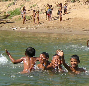 Boys swimming in tributary of Mekong River.